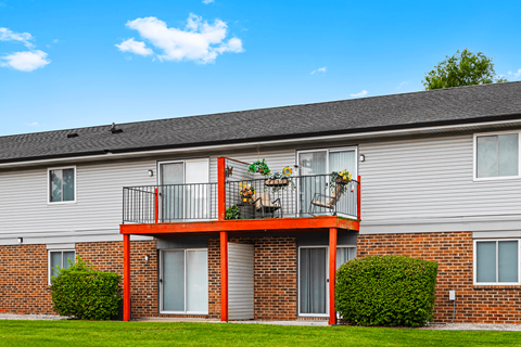 Exterior view of Blueridge Terrace Apartments, featuring balconies and patios on upper and lower levels.