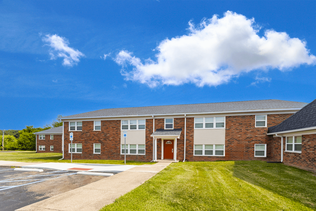 Exterior view of Country View Apartments, showcasing a charming building design surrounded by lush greenery.