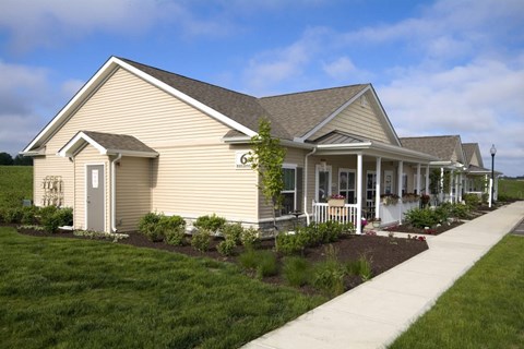 Front exterior of Meredith Meadows Apartments building with landscaped surroundings.