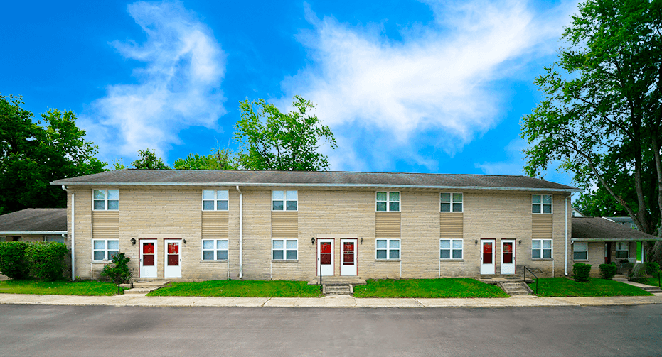 Apartment building with red doors and windows.
