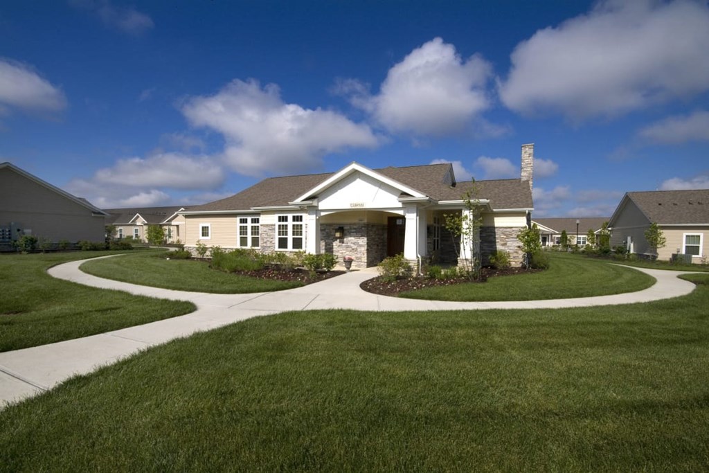 Meredith Meadows Apartments exterior with adjacent walking trail and greenery.