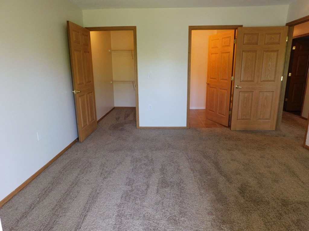 Unfurnished bedroom with a closet at Chapelgate Park Apartments