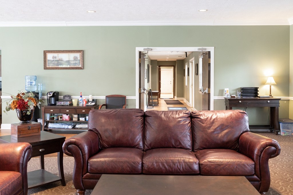 a living room with a leather couch and a coffee table