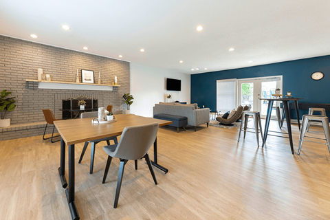 A modern dining room with a wooden table and chairs.