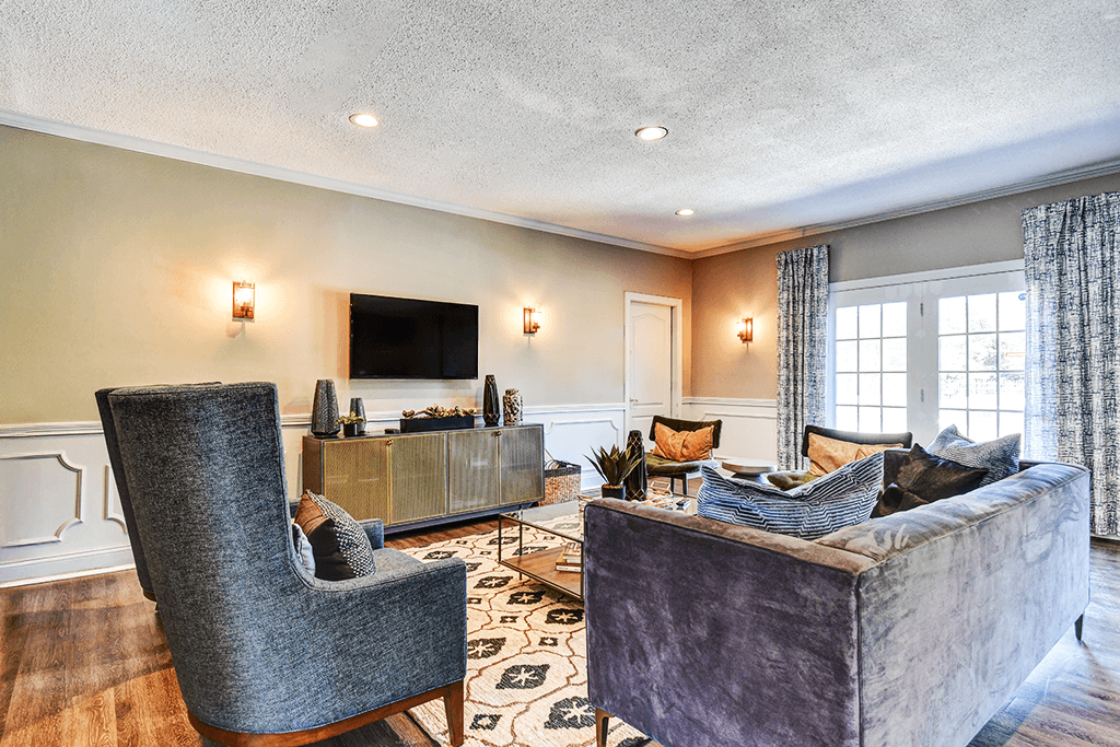 Clubhouse lounge at Ashton Brook Apartments, featuring comfortable seating and a TV.