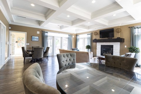 A living room with a fireplace and a glass table.