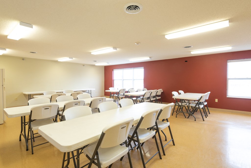 Community room with ample seating at Kirby Manor