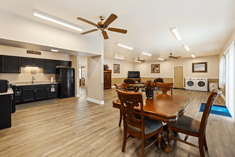 A dining room with a wooden table and chairs.