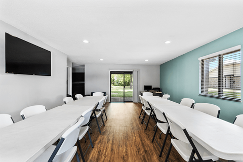 Community room at Lebanon Manor Apartments with tables and chairs.