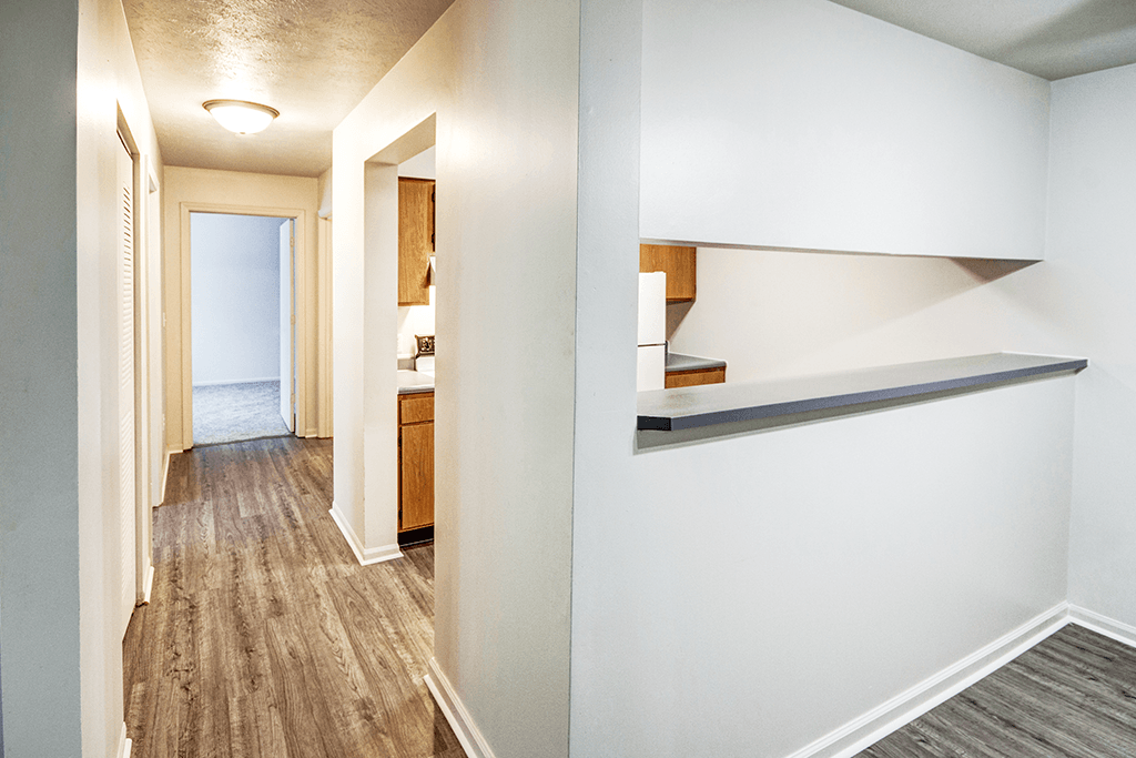 Corridor of a 2-bedroom, 1-bath apartment at Woodland Crossing, showcasing entryway with wood flooring and access to living spaces.