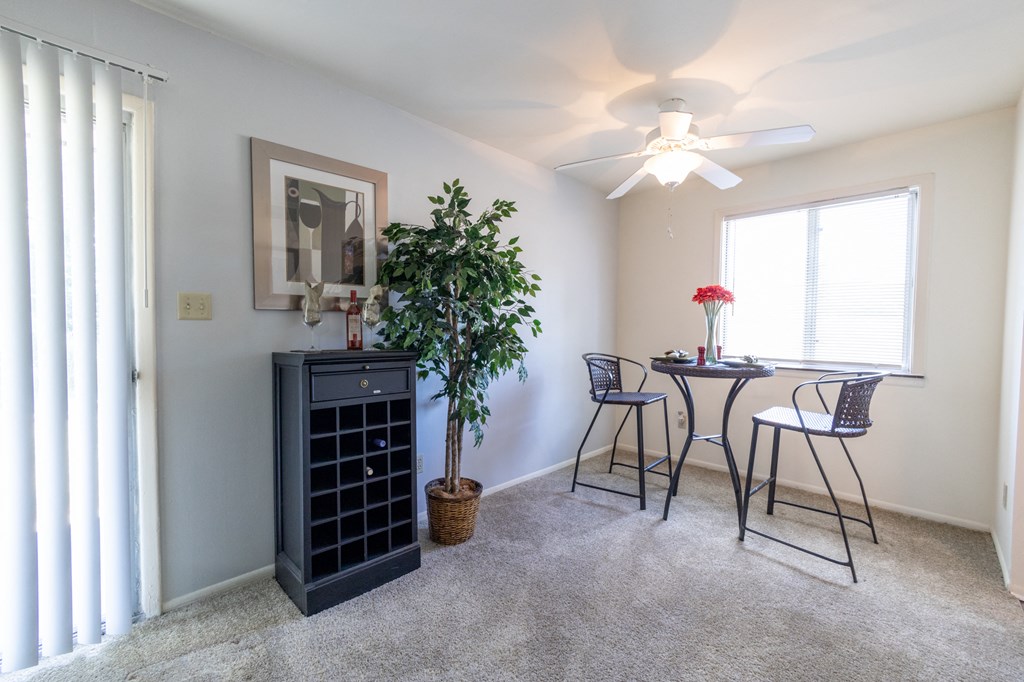 Dining room with a window and patio access at Woodbridge Apartments