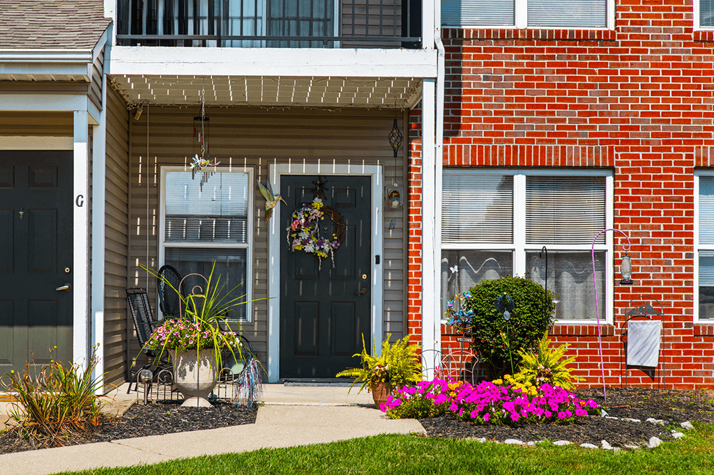 Ground-level porch of a walk-up apartment at Brownsburg Pointe, featuring a private entrance and covered seating area.