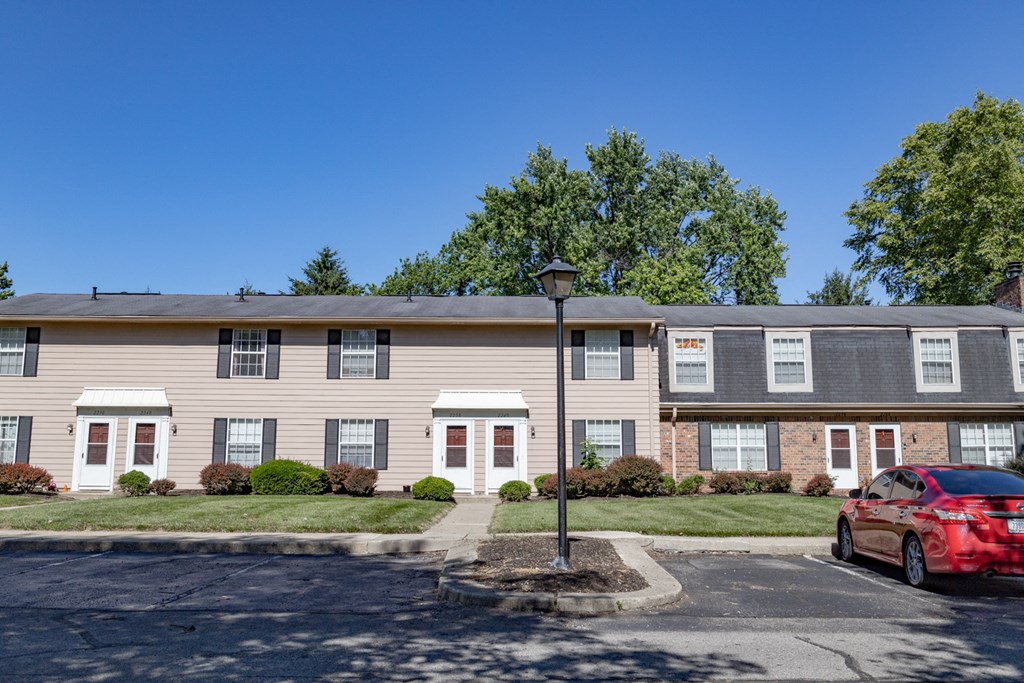 Apartment Building Exterior with parking and street lights in front at Briarwood Apartments in Columbus, IN