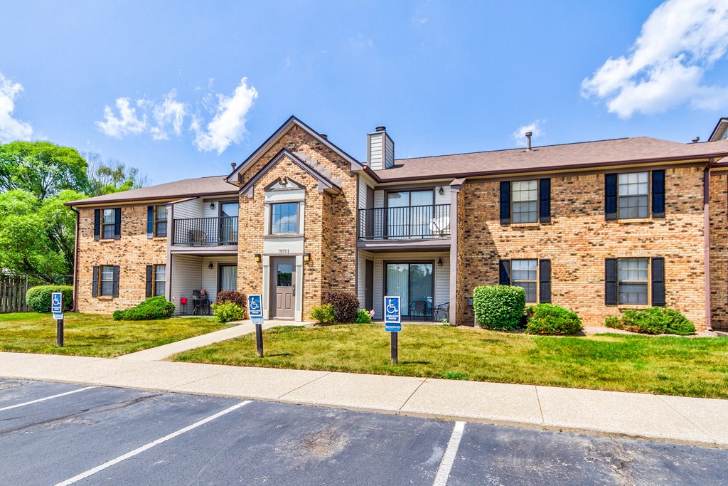Exterior Apartment Building at Cedar Ridge Apartments Exterior view of Cedar Ridge Apartments with parking lot