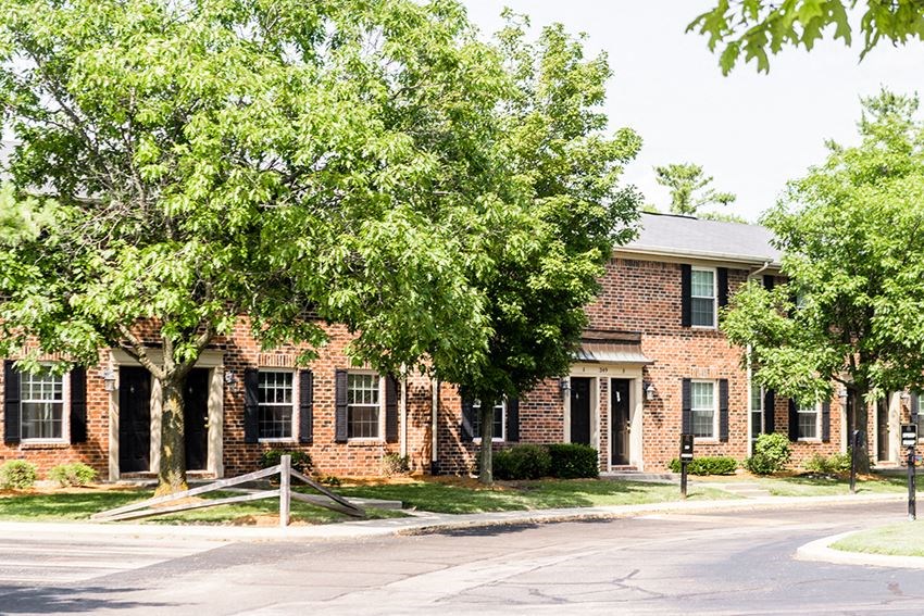 a brick building with a tree in front of it