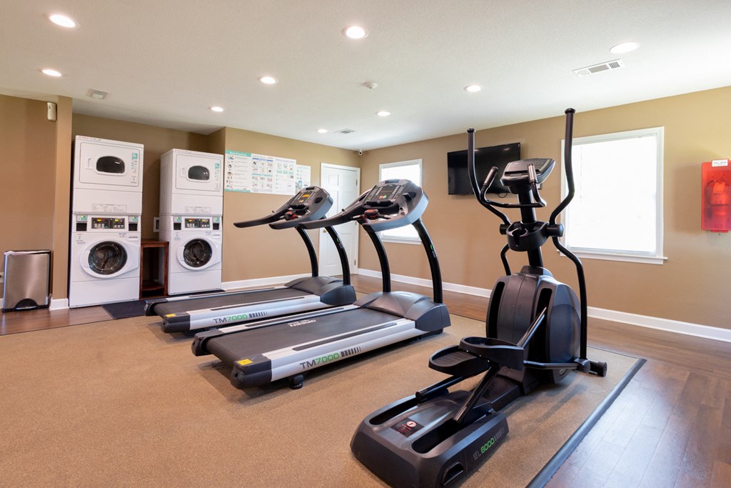 Fitness Center at Archer's Pointe with treadmills, elliptical machine and washer and dryer sets.