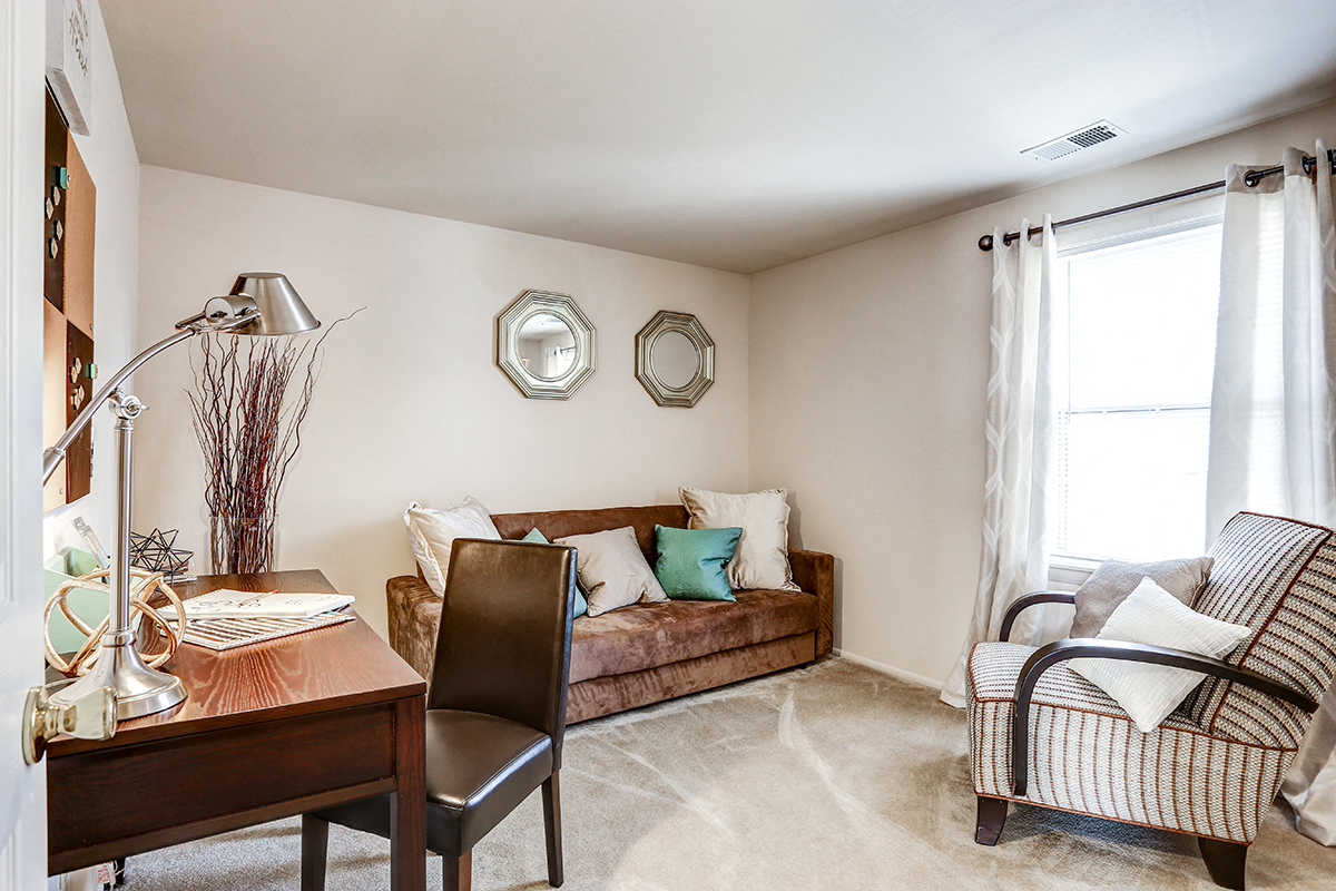 Bright guest bedroom with a window at Archer's Pointe.