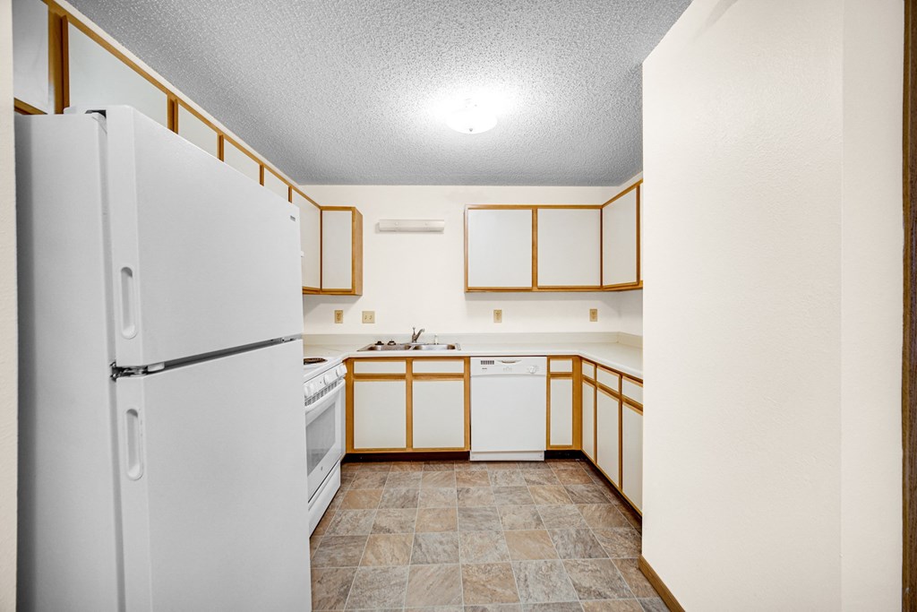 Kitchen with oven, dishwasher and refrigerator at Kirby Manor