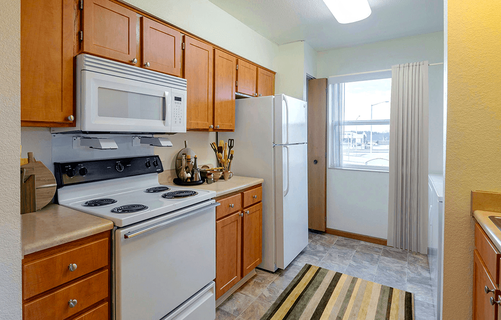Kitchen with a stove, microwave, and refrigerator  at Copper Gate, Lafayette, 47909