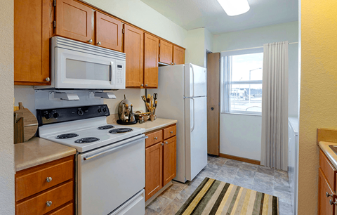 Kitchen with a stove, microwave, and refrigerator  at Copper Gate, Lafayette, 47909