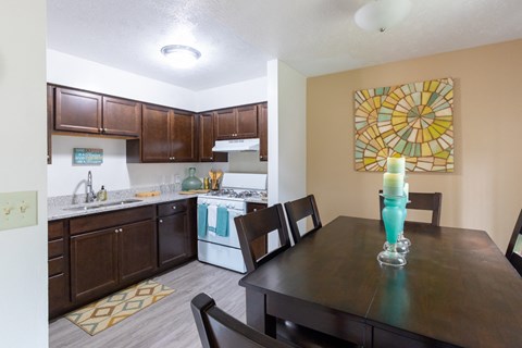 a kitchen and dining room with a table and chairs