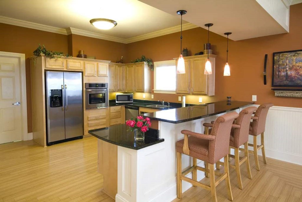 Kitchenette area in Meredith Meadows Apartments with modern appliances and cabinetry.
