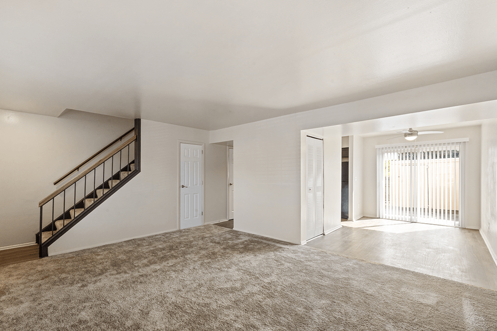 Living and dining area in a 2-bed, 1.5-bath townhome at Carriage House Apartments, Kendallville, featuring an open layout and natural light.