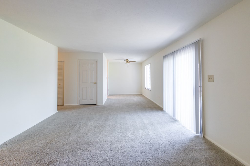 Living and dining room with patio access in the 2 bedroom apartment at Woodbridge Apartments