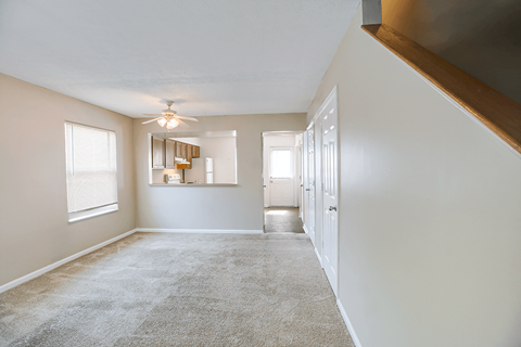 Living room in a 2- or 3-bedroom townhome at Hampton Place Apartments, featuring a spacious layout and natural light.