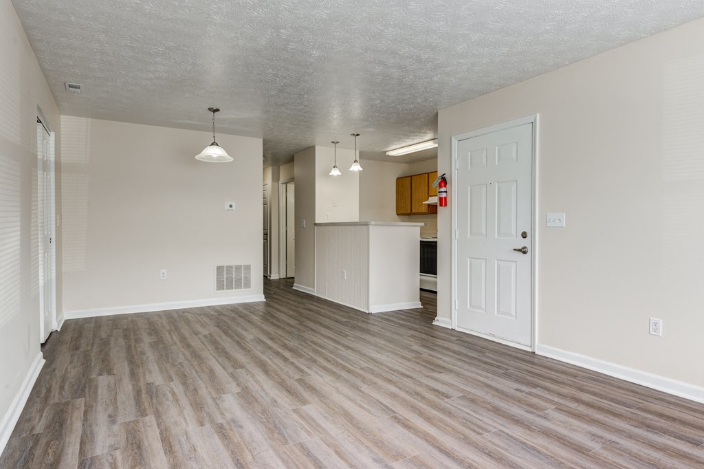 Living room and kitchen with wood flooring at Brownsburg Pointe.