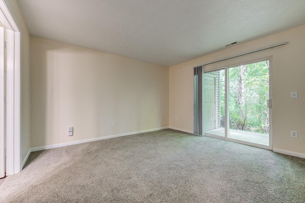 Living room with a sliding glass door to the patio at Brownsburg Pointe.