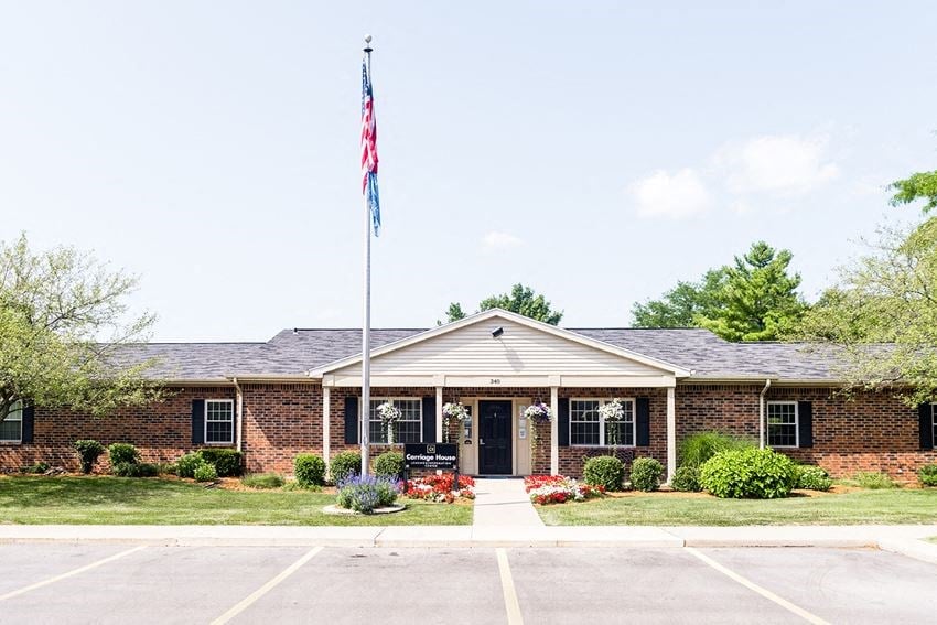 the front of a brick house with an flag