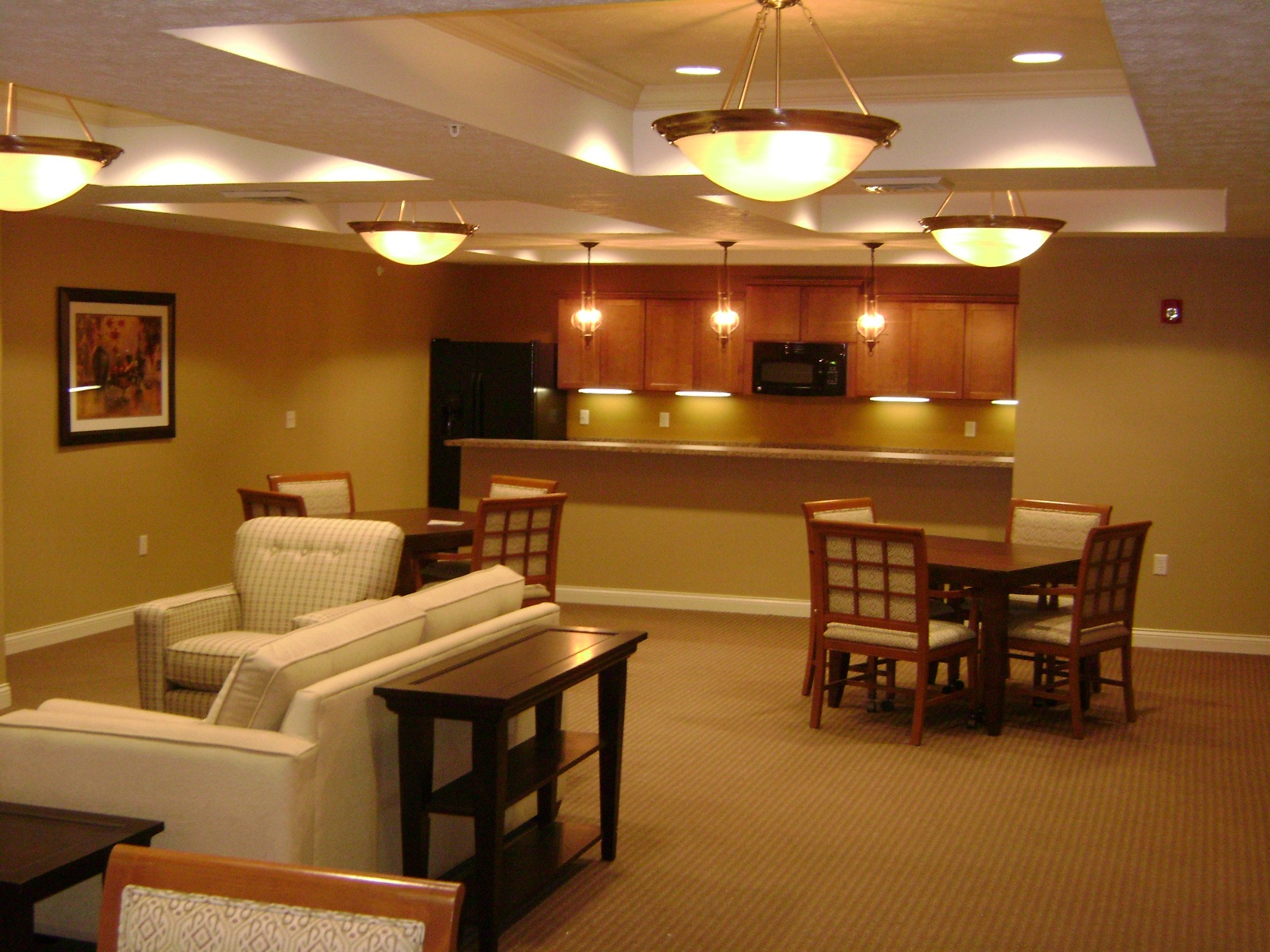 A living room with a couch, chairs, and a television.