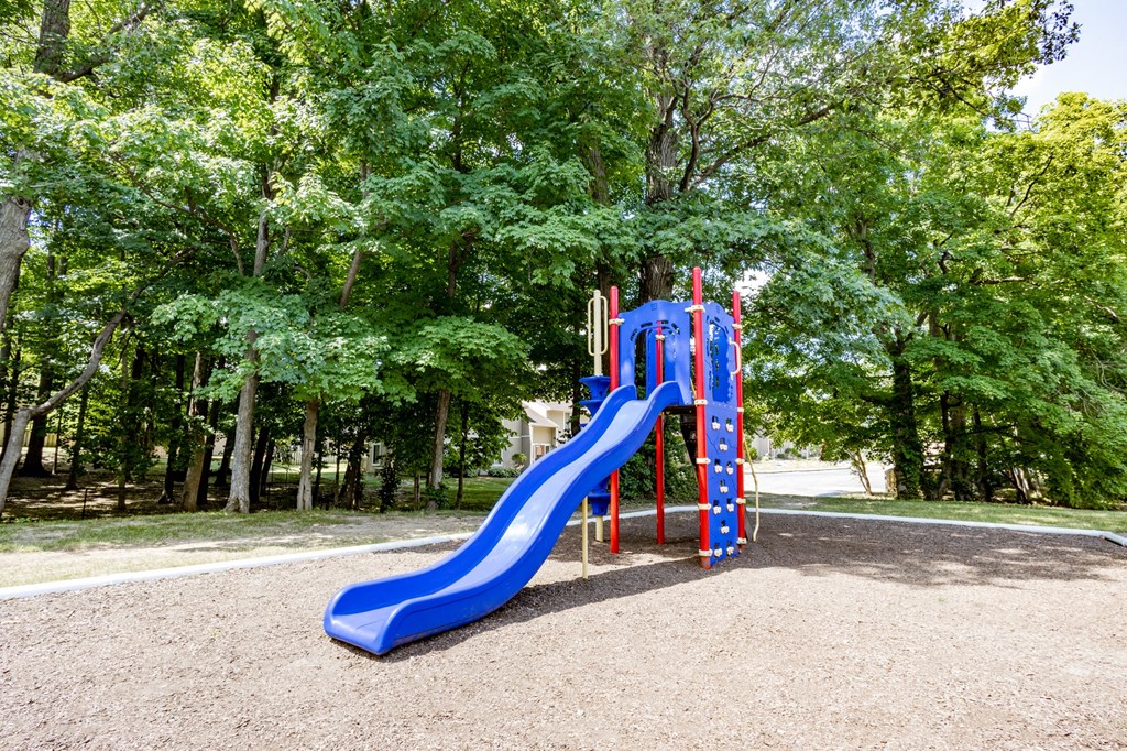 Playground with a slide and climbing apparatus at Woodbridge Apartments