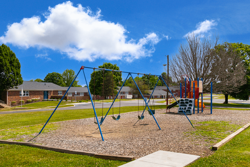 Colorful playground at Country View Apartments, featuring swings, slides, and play structures.