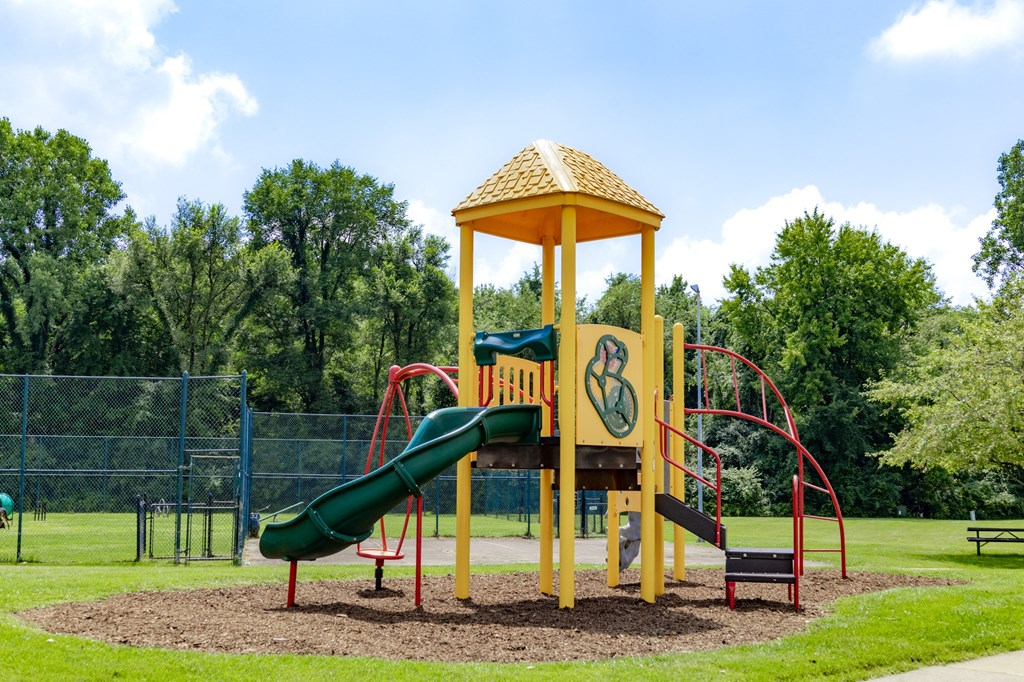 a playground with a slide and a pavilion