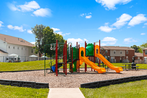 Playground at Windsor Park Apartments, featuring colorful play equipment for children to enjoy.