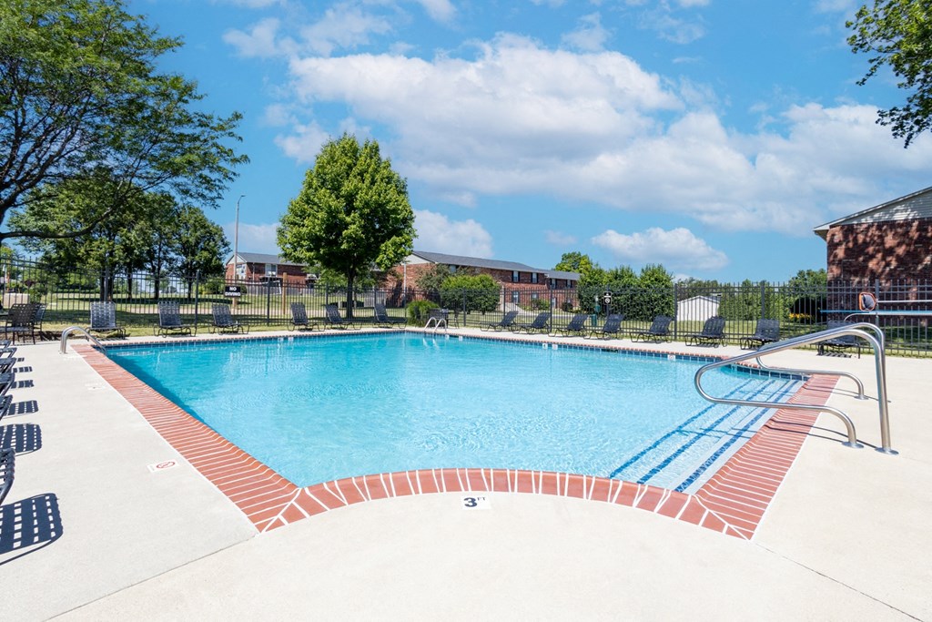 Outdoor pool with seating at Archer's Pointe.