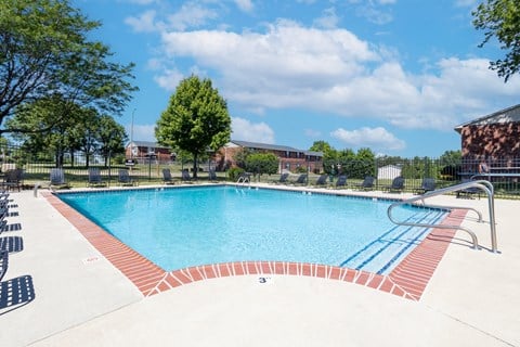 Outdoor pool with seating at Archer's Pointe.