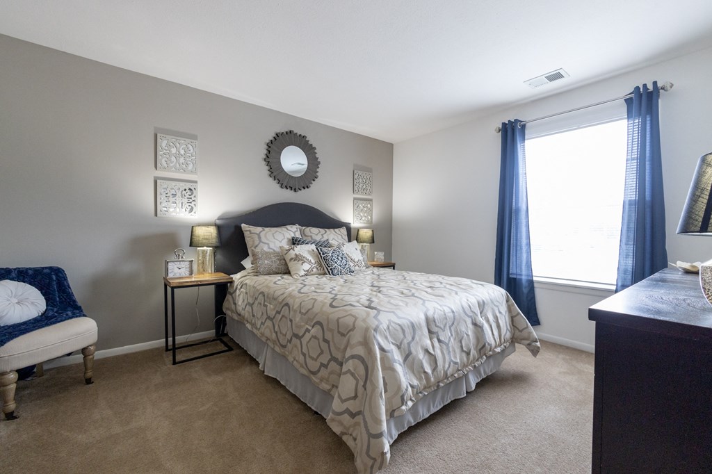 2 Bedroom Master Floorplan at University Park Apartments a bedroom with a bed and a window