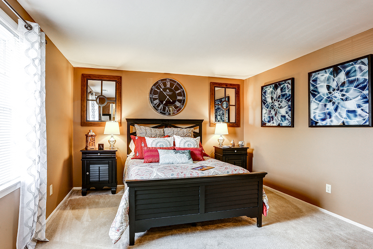 Bright primary bedroom with a window at Archer's Pointe.