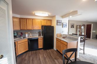 Kitchen with oven, dishwasher, refrigerator, and pantry at Archer's Pointe.