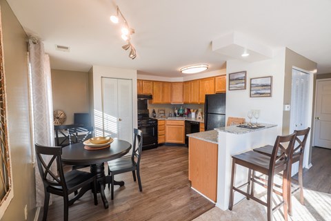 a kitchen and dining area with a table and chairs