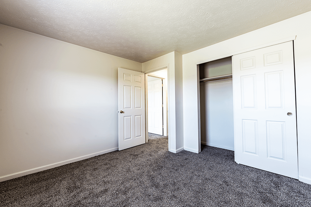 Secondary bedroom with carpets in a two-bedroom, two-bath apartment at North Lake Apartments.