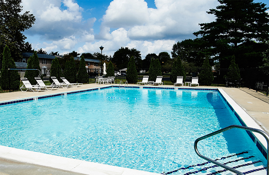 Swimming Pool with outdoor seating around the pool at Briarwood Apartments in Columbus, IN