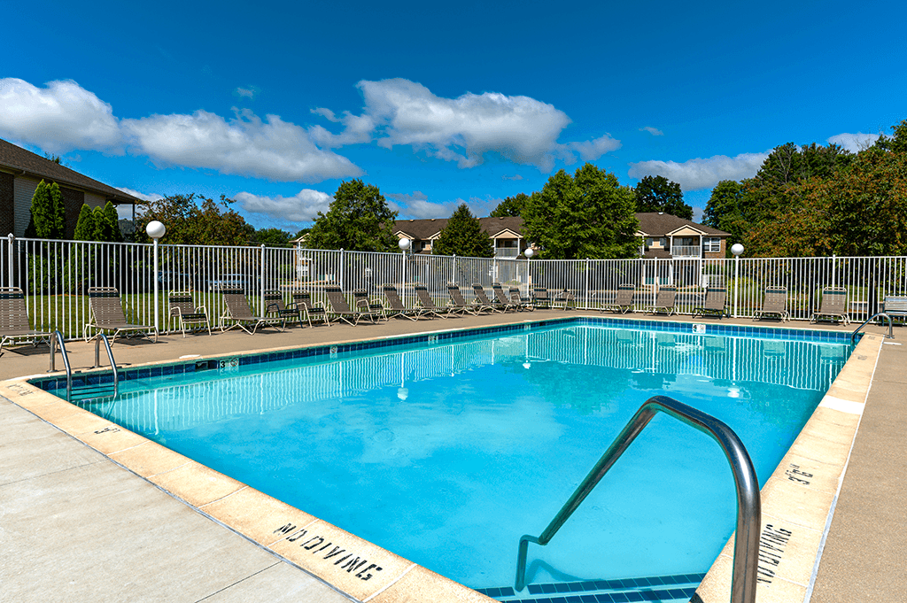Swimming pool with seating at North Lake Apartments.