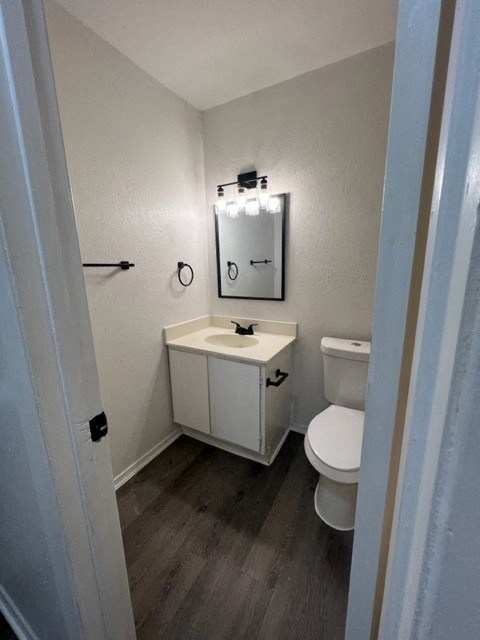 a bathroom with a toilet and a sink and a mirror