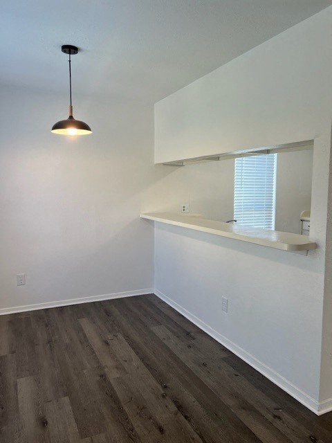 an empty room with a counter and a light