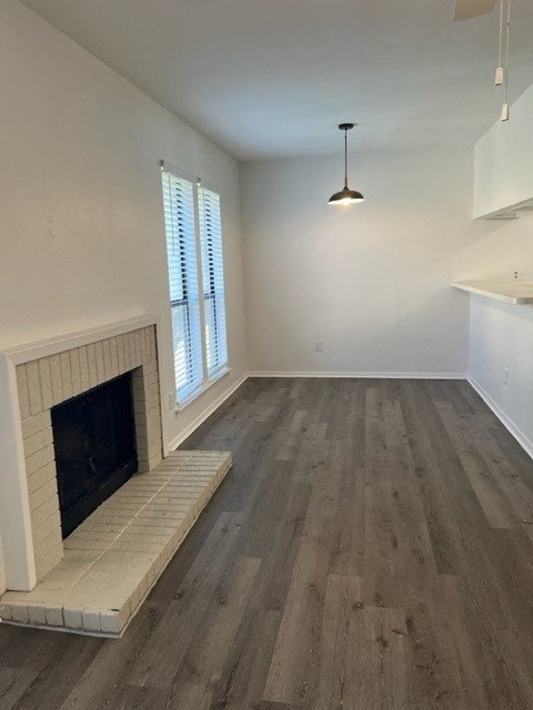 a living room with a fireplace and a wooden floor