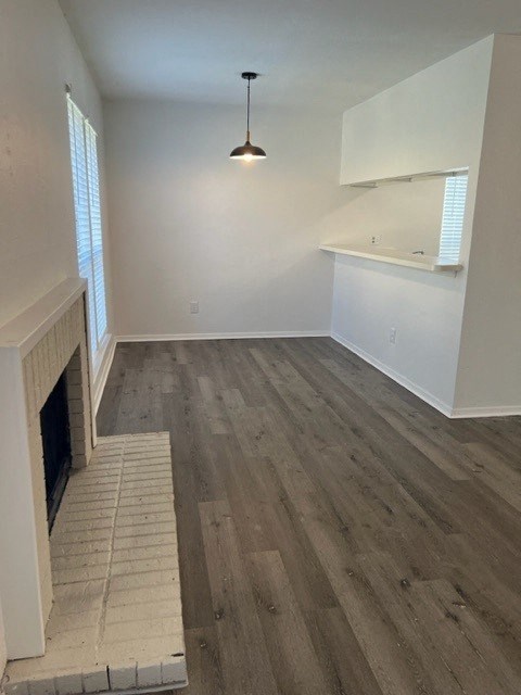 a living room with wood floors and a fireplace